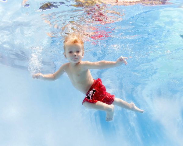child swimming at AquaChamps Swim School